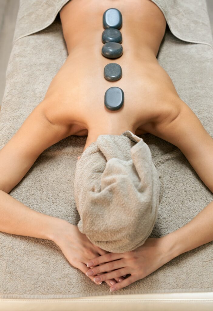 Woman in spa salon having hot stone massage
